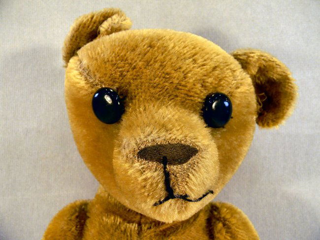 old teddy bear stuffed with straw